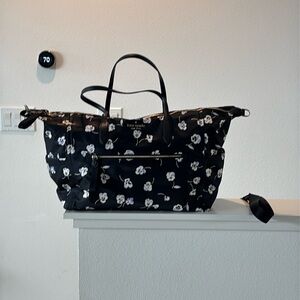 New never used. Kate Spade overnight bag, floral images on satin black.